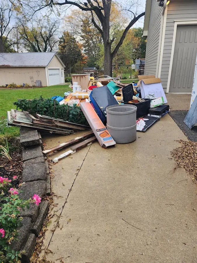 Dumpster being loaded with debris for Estate Cleanout Dumpster Rental in Williston Highlands